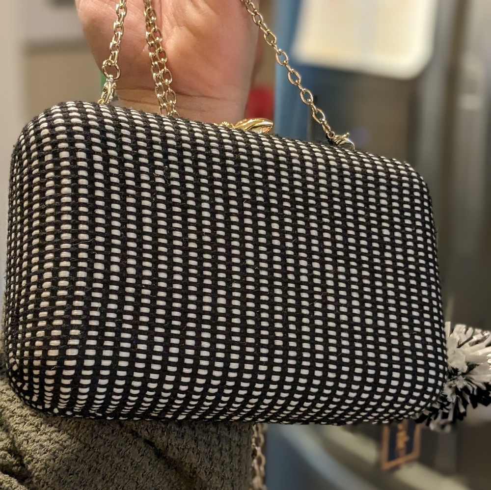 Two tone minaudiere evening bag with pom pom detail and a chic bumble bee clasp